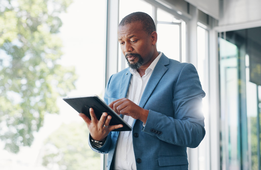Employee in a suit looking at a tablet