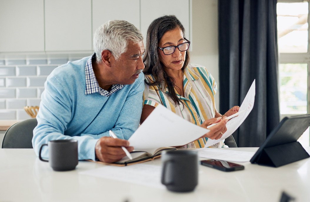 Two people looking at paper work
