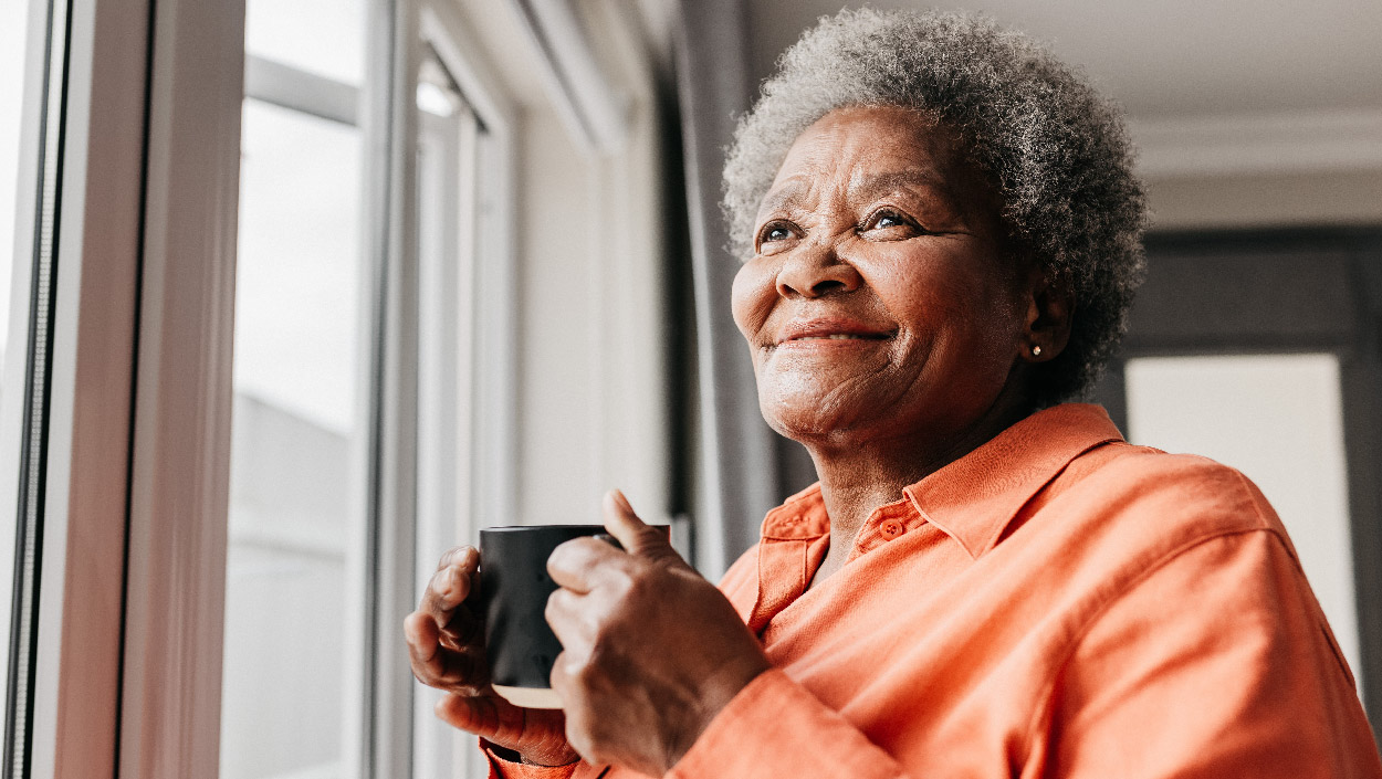 Person smiling and looking out the window