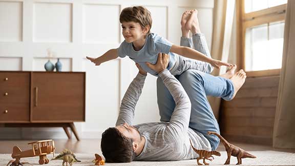 father and son playing at home