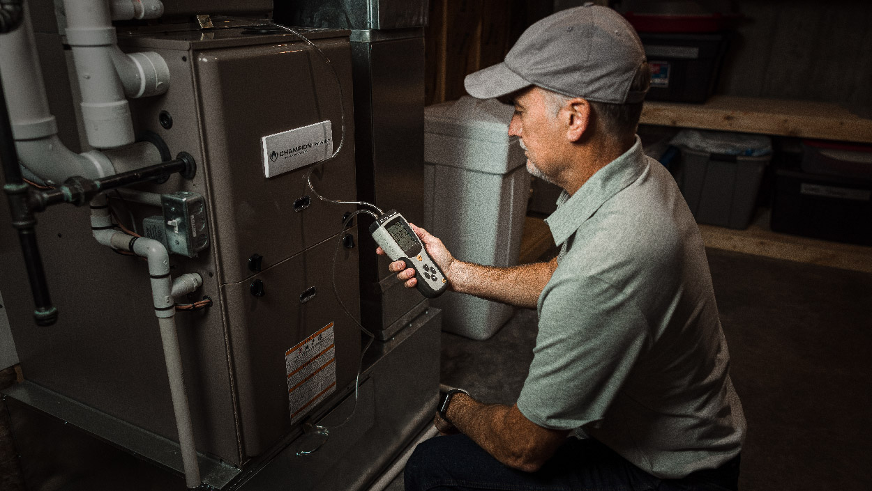 Maintenance technician looking at HVAC unit
