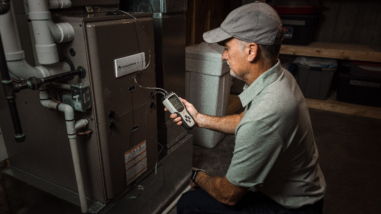 Maintenance technician looking at HVAC unit