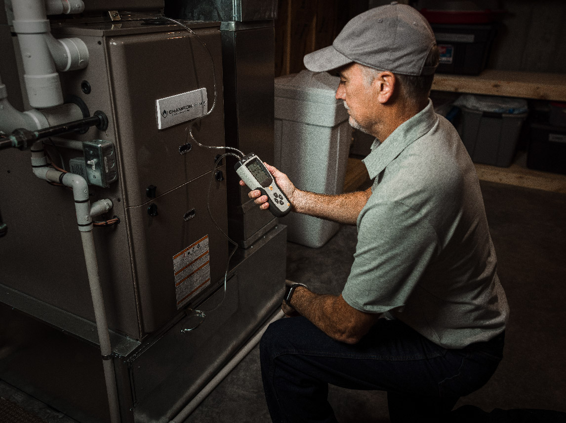 Maintenance technician looking at HVAC unit