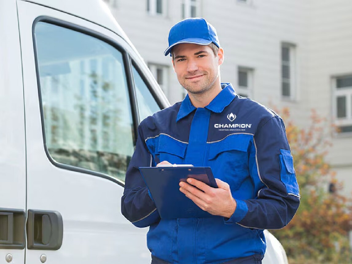 Champion Employee holding clipboard outside of work van